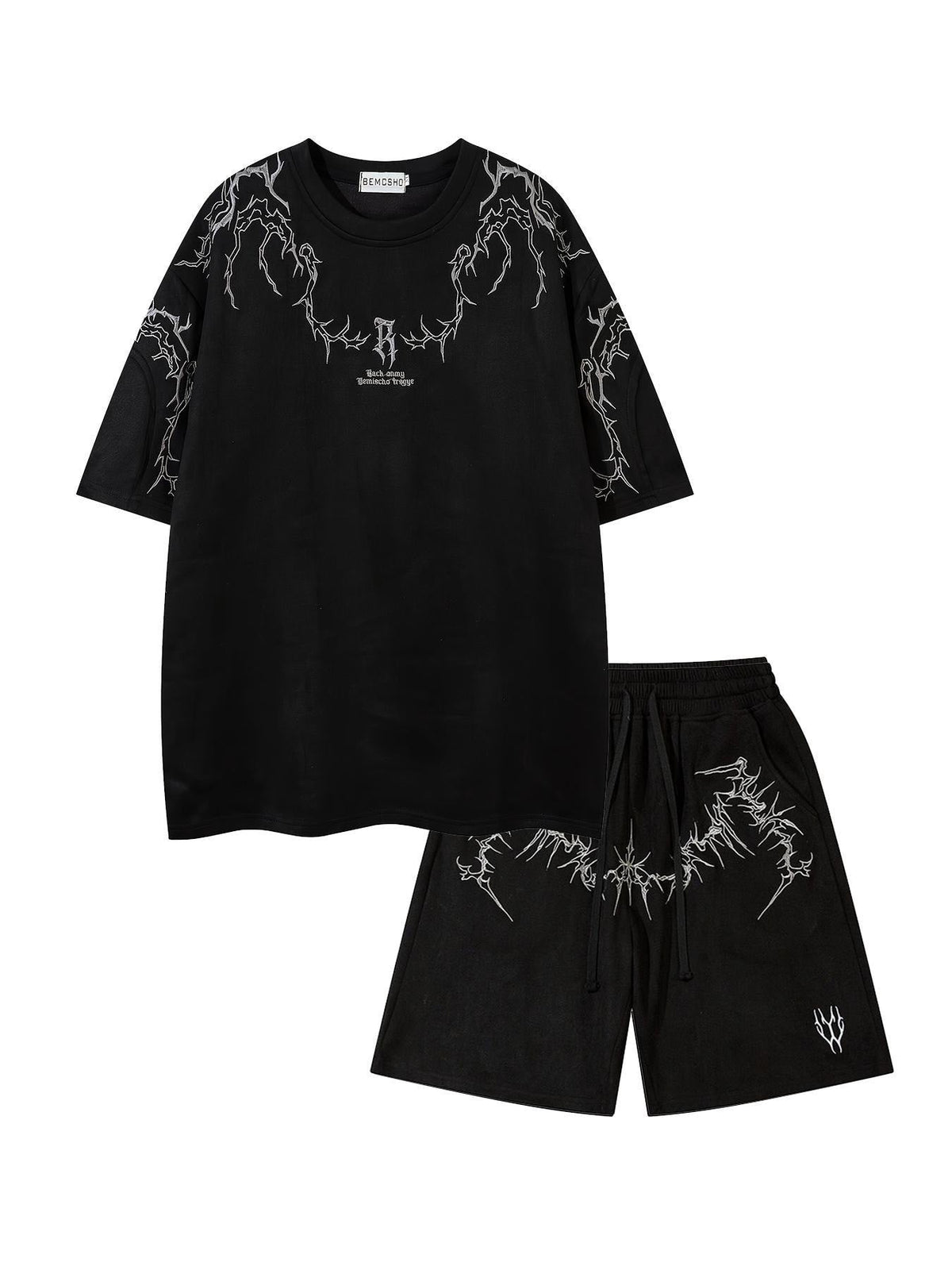 Ensemble t-shirt brodé et short — noir présenté à plat, broderies blanches au col et sur le short