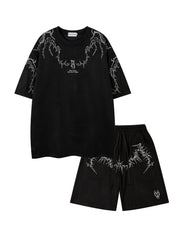 Ensemble t-shirt brodé et short — noir présenté à plat, broderies blanches au col et sur le short