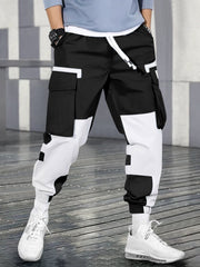 Pantalon cargo contrastes couleurs noir et blanc — vue portée de face, devant un mur gris