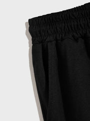 Ensemble gilet capuche short noir — détail de la taille élastique et de la poche latérale du short