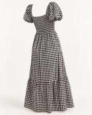 Robe Tina vichy noir et blanc, vue de dos de trois quarts de la pièce seule, buste smocké et manches bouffantes.