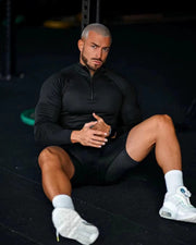 Haut demi-zip noir à manches longues, vue portée assise