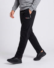 Pantalon jogging cordon poches zippées noir — vue portée en marche, de profil