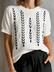 Pull écru motifs épis noirs — gros plan de la broderie d'épis et de l'encolure ronde