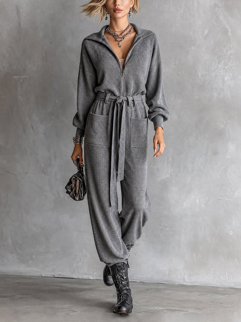 Combinaison grise à taille nouée — vue portée de face, col chemise et ceinture nouée, sac noir