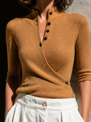 Pull camel croisé col montant — gros plan de l'encolure croisée, des quatre boutons sombres et de la maille côtelée