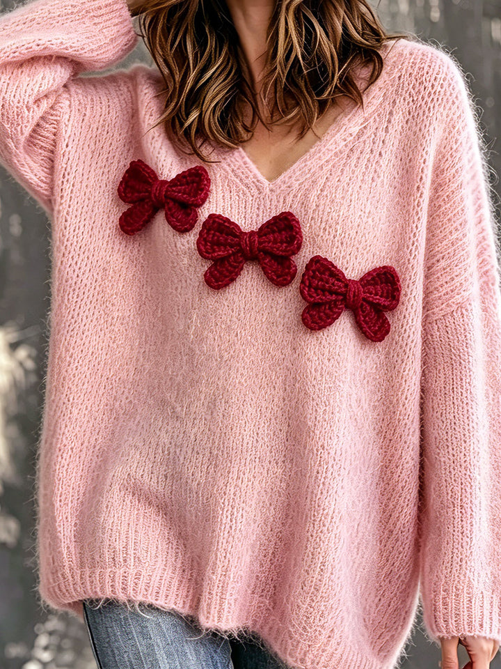 Pull rose à col V et nœuds décoratifs — vue de dos. Soniel Paris.