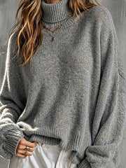 Pull gris à manches lanternes — gros plan du buste et du col roulé