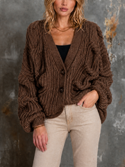 Cardigan brun à torsades — vue portée de face, cadrée à la taille, mains le long du corps