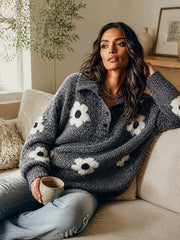 Pull gris boutonné à fleurs — vue portée assise sur un canapé beige, tasse blanche