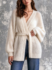 Cardigan blanc crème ceinturé — vue portée en pied, ceinture assortie, jean bleu, regard baissé