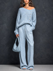 Ensemble pull asymétrique pantalon droit — vue portée en pied, sac à main assorti