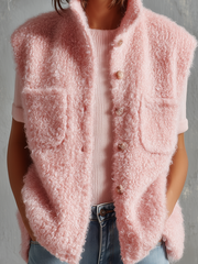 Gilet rose duveteux col montant — gros plan de la maille, des boutons et des poches plaquées