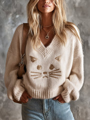 Pull beige chat col V — vue portée de face, tête de chat brodée sur le devant
