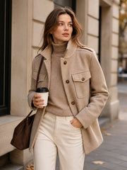 Manteau court kaki à épaulettes — vue portée en marche dans la rue, sac à main marron