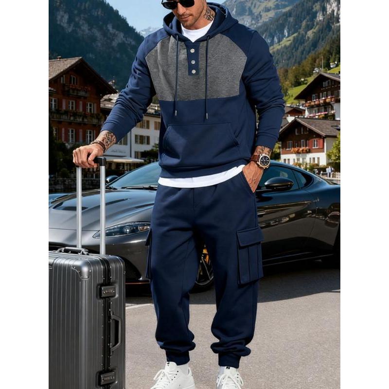 Ensemble sweat à capuche bleu marine — vue portée de face, valise à la main