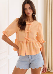 Blouse péplum à carreaux