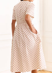 Robe crème à pois rouges