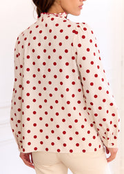 Chemise beige à pois rouges