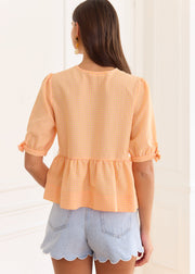 Blouse péplum à carreaux