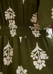 Détail de la taille froncée au dos de la robe kaki à motifs écrus.