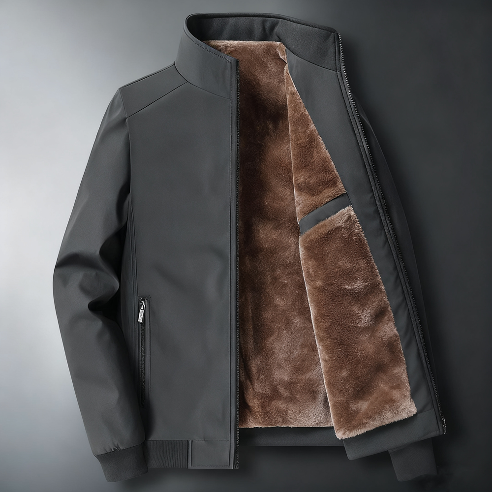 Veste gris sombre à col montant, ouverte sur un intérieur brun duveteux.