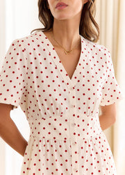 Robe crème à pois rouges