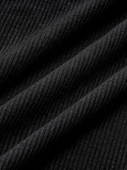 Top manches longues passepoilé noir — gros plan sur les plis du tissu