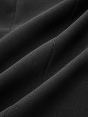 Blazer noir à nœud — gros plan du tissu