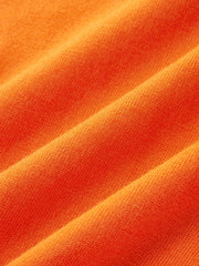 Top tricot bordure contrastée orange — gros plan sur la maille