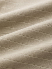 Pantalon ample à taille rabattue beige, détail du tissu