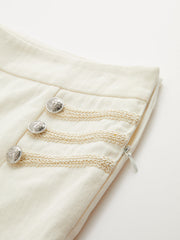 Pantalon évasé brodé ivoire, détail des boutons