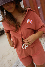 Chemise éponge loose portée par une femme, vue rapprochée, short assorti, étiquette