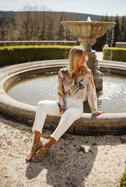 Chemise imprimée manches longues portée par une femme, assise, margelle de fontaine, bottines