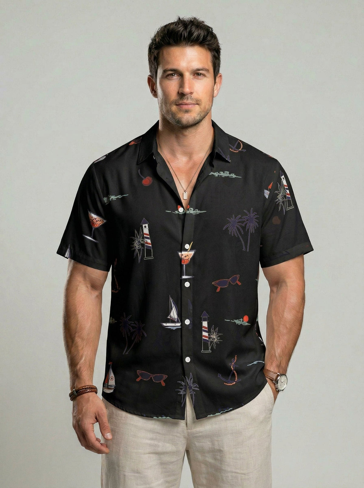Chemise à imprimé tropical — noire portée de face, motifs palmiers et voiliers