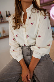 Chemise fleurie à manches longues portée par une femme, vue rapprochée, manches, fleurs
