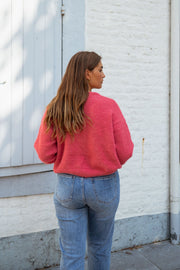 Gilet doux légèrement loose framboise porté par une femme, vue de dos, volets, cheveux longs