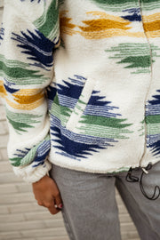 Gilet polaire zippé à motifs écru porté par une femme, vue rapprochée, poche, cordon