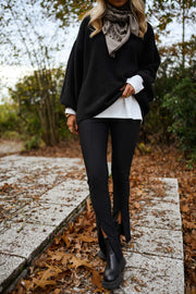 Legging moulant fendu porté par une femme, silhouette entière, veste noire, bottines