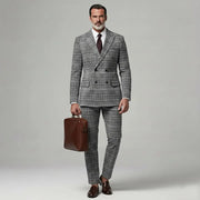 Ensemble blazer carreaux — vue portée de face, mallette en cuir marron à la main