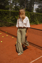 Pantalon fluide à pois porté par une femme, silhouette entière, court, filet, balles