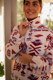 Polaire zippée à motifs écrue portée par une femme, vue rapprochée, col zippé, sourire, autre cadrage