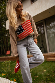 Pull à drapeau col rond camel porté par une femme, vue de face, drapeau américain, jean