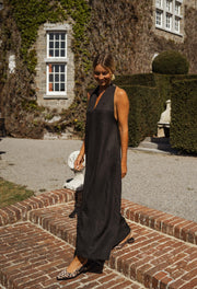 Robe fluide à dos ouvert portée par une femme, vue de face, brique, fleurs