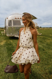 Robe à pois dos nu portée par une femme, silhouette entière, camping-car, herbe