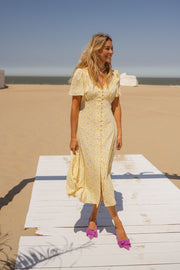 Robe satinée à boutons portée par une femme, vue de face, ponton blanc, plage