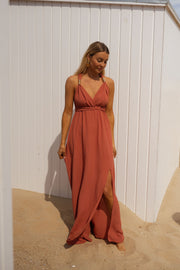 Robe fluide dos ouvert portée par une femme, vue de dos, sable, nœud dans le dos
