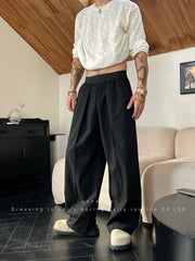 Pantalon ample uni à plis noir — vue portée de profil, coupe ample