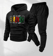 Ensemble veste capuche pantalon — noir présenté à plat de face, sweat imprimé texte multicolore et jogging