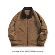 Veste marron à texture côtelée et col noir, zippée de face, avec deux poches plaquées.